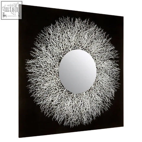 A white coral-like framed circular abstract mirrored wall art against black background for stylish decor