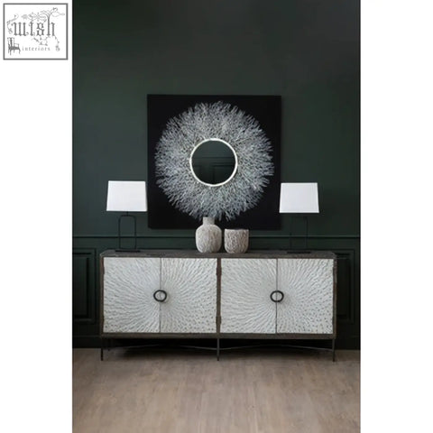 Silver textured sideboard with black metal frame and circular handles paired with modello abstract mirrored wall art