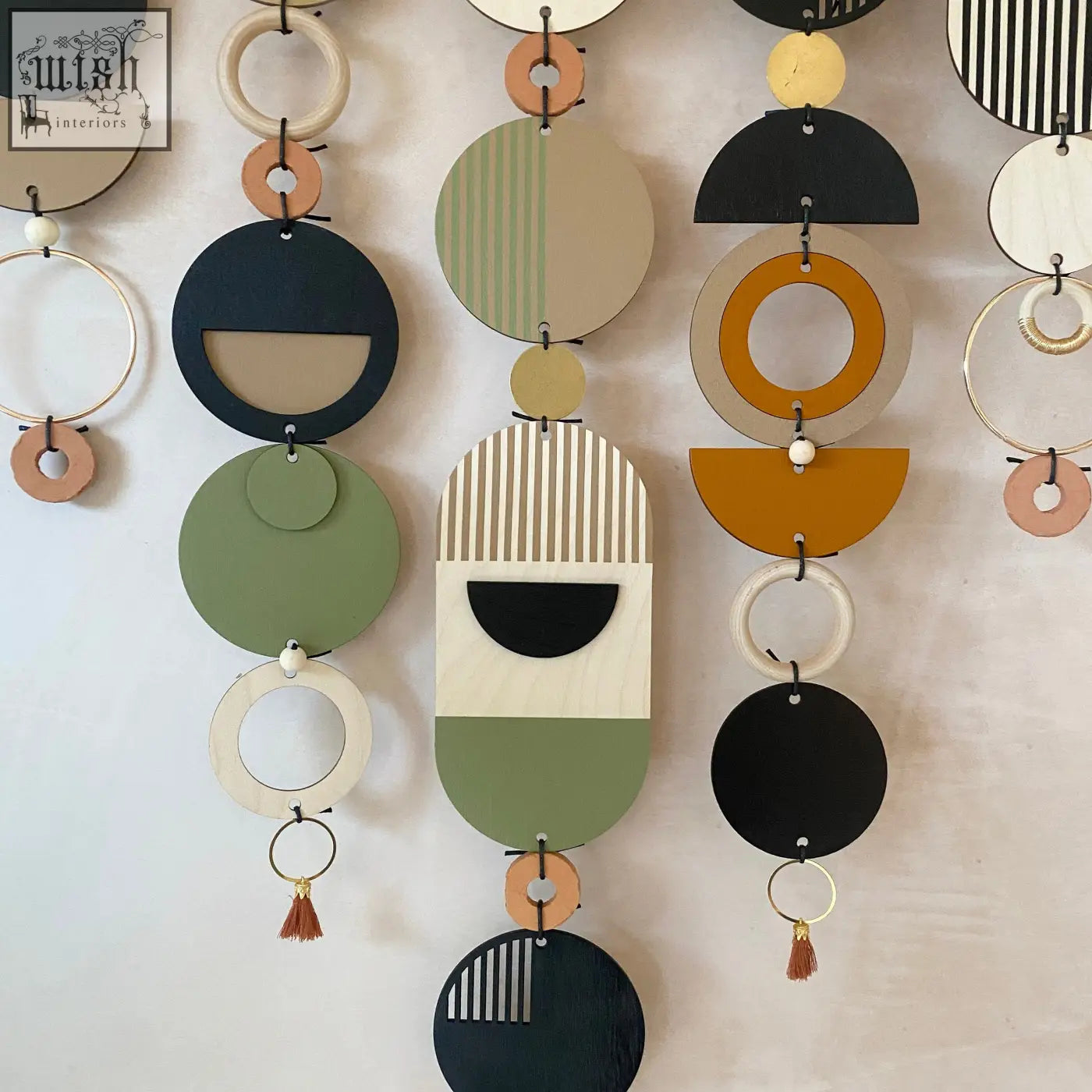 Modern art wooden wall hanging with hand painted geometric shapes in muted colors winner of design awards wall art
