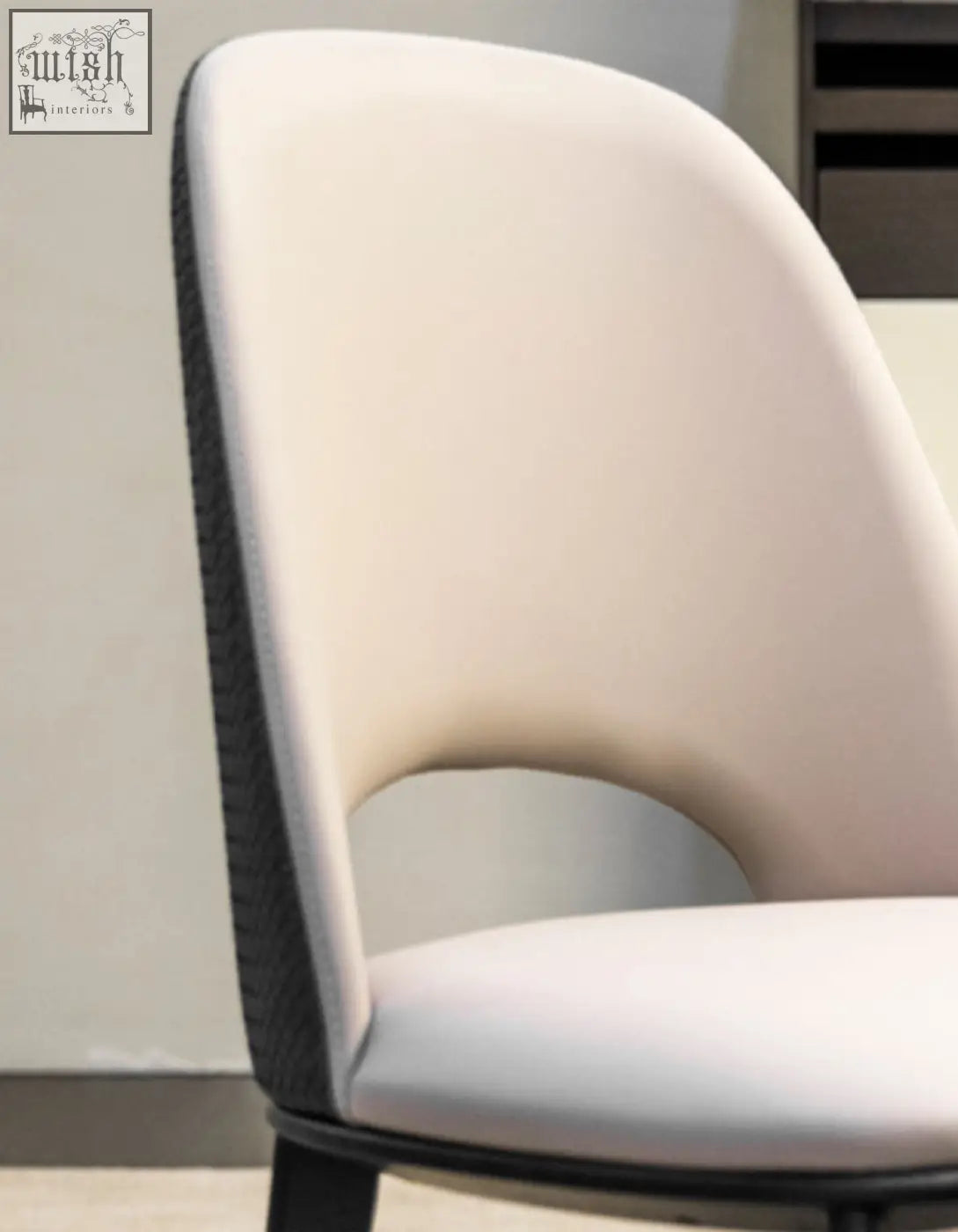 Cream-colored upholstered modern contexture dining chair with sleek black trim and minimalist design
