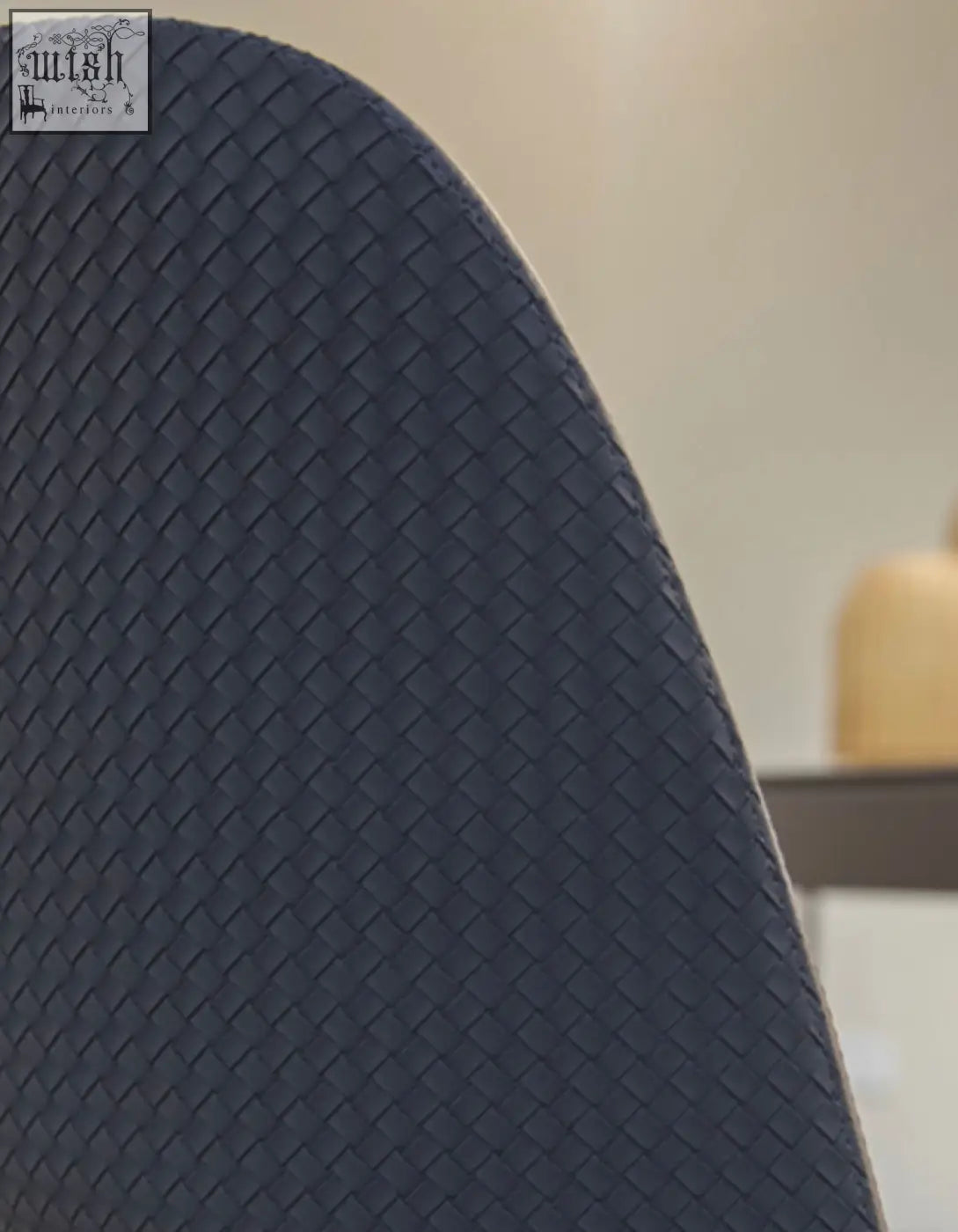 Back side of a dark gray woven texture modern contexture dining chair backrest for stylish dining rooms