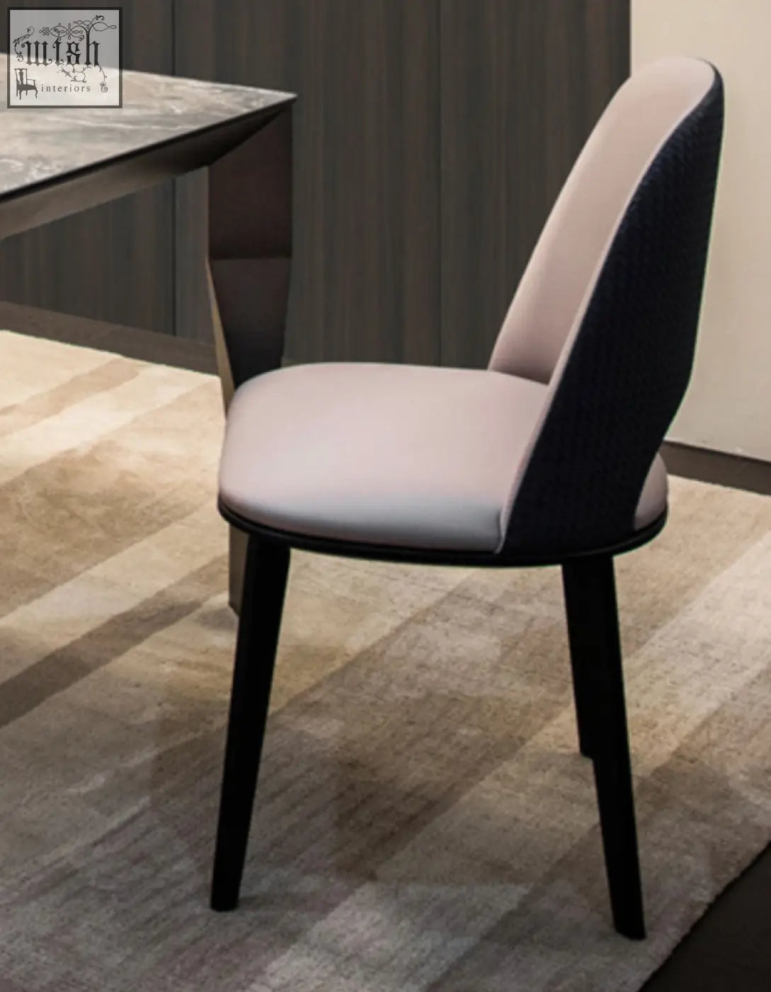Modern contexture dining chair with sleek black frame and soft beige upholstered seat and back in minimalist style