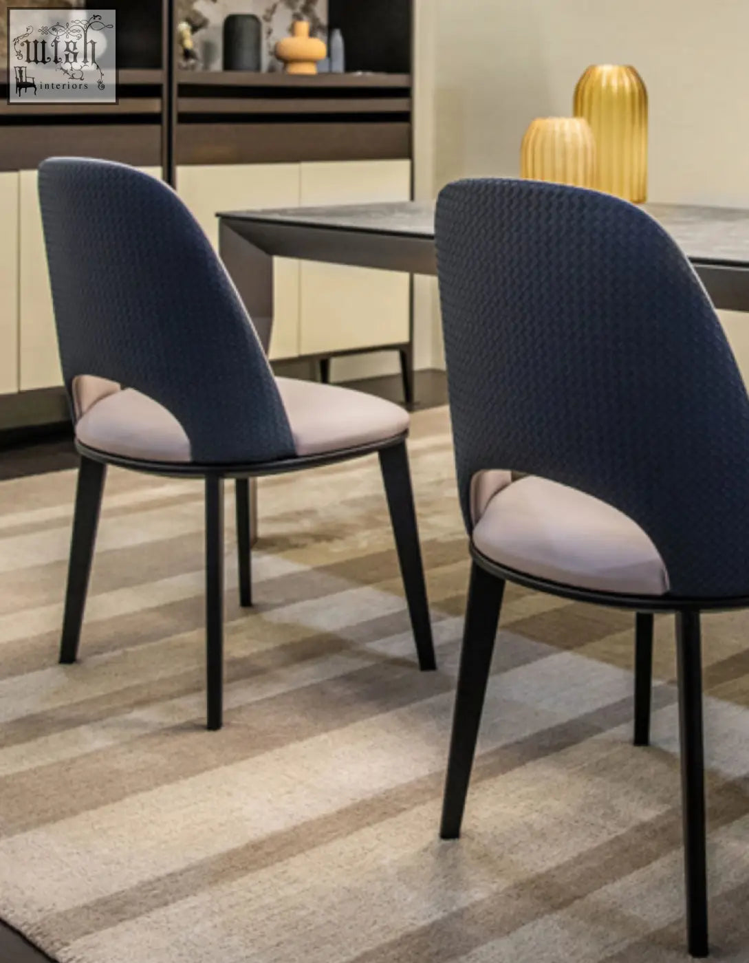 Modern contexture dining chair in navy blue upholstery with light gray cushions and sleek black metal legs