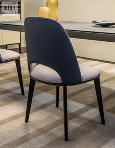 Modern contexture dining chair with a modern navy blue woven back, light gray upholstered seat, and black metal legs