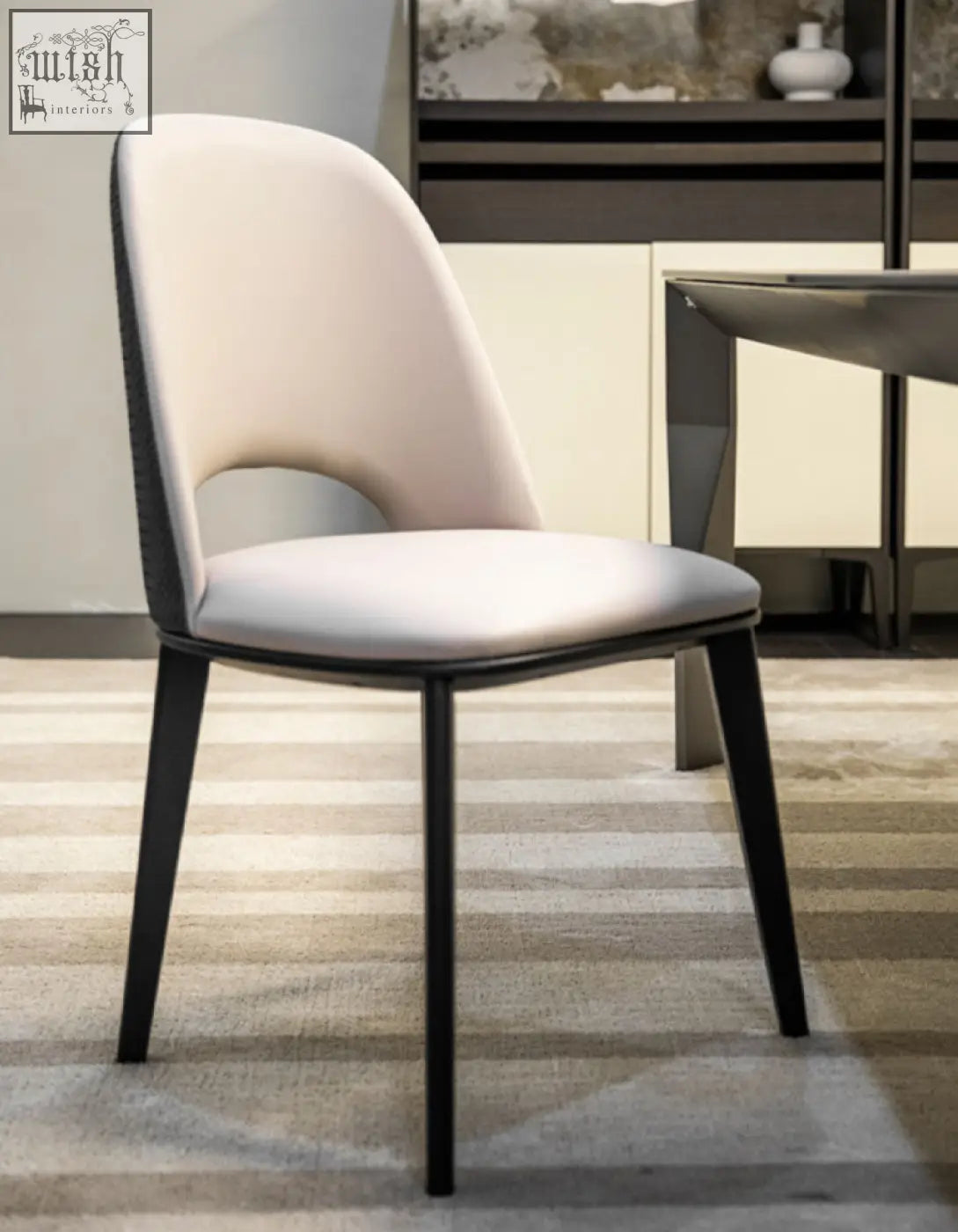 Modern contexture dining chair with cream upholstered seat and backrest and black metal legs in sleek minimalist style