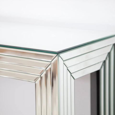 A sleek modern glass top mirrored console table with silver frame and geometric glass panels perfect for living room