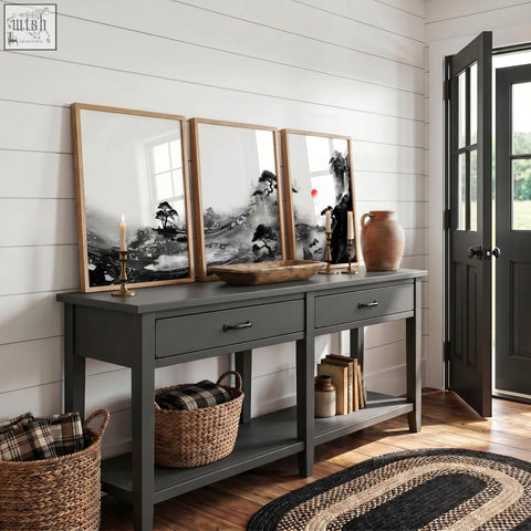 Gray painted console table with drawers and open shelves featuring rustic design and dark metal handles with modern japanese art prints
