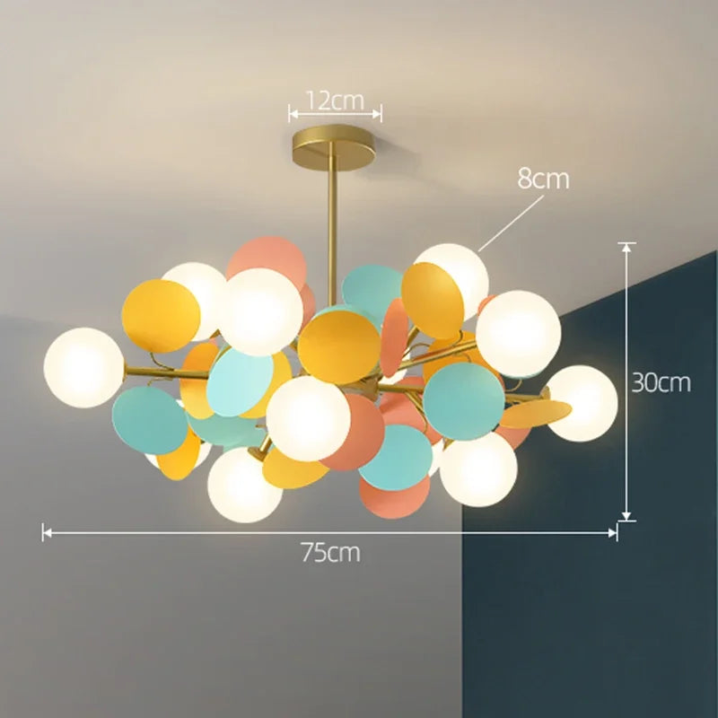 A modern led chandelier with brass finish and pastel yellow teal coral white glass shades as light source