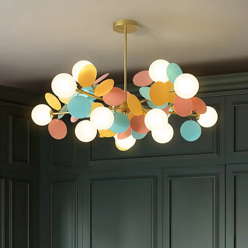 A modern led chandelier with brass finish and pastel colorful glass shades as a stylish light source for luxury ceilings
