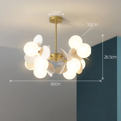 A modern led chandelier with a brass metal frame and frosted glass orbs as a stylish light source fixture