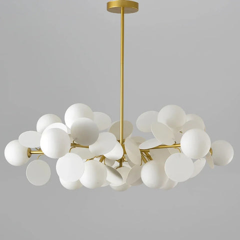 Gold-toned modern led chandelier with frosted white glass shades in a cloud-like cluster as a unique light source