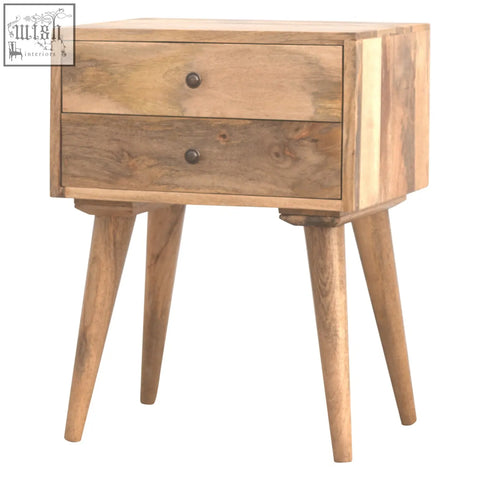 A rustic solid wood bedside table with two drawers and dark metal knobs supported by four tapered legs