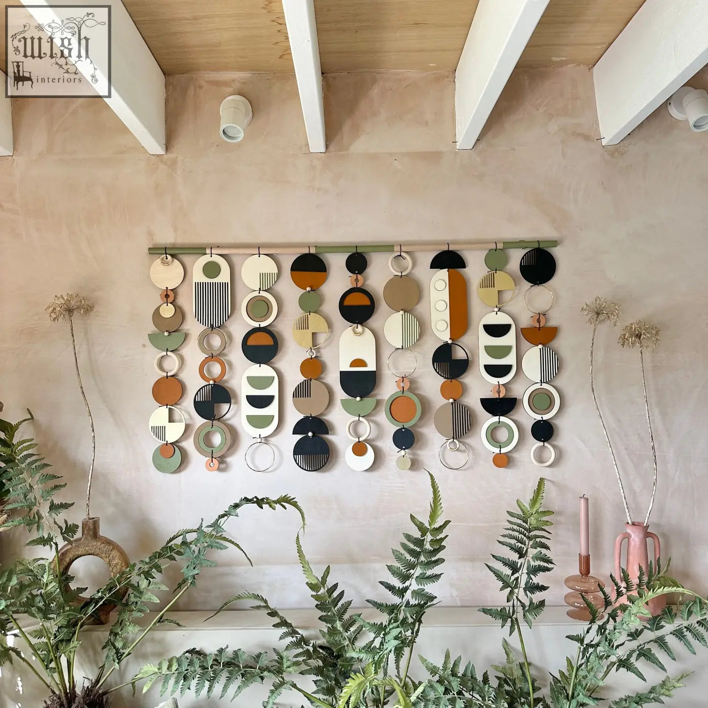 A modern wall art tapestry with layered circular shapes in beige olive green terracotta black and white for home decor