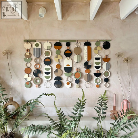Modern wall art featuring layered circular shapes in olive green terracotta black and beige for minimal home decor