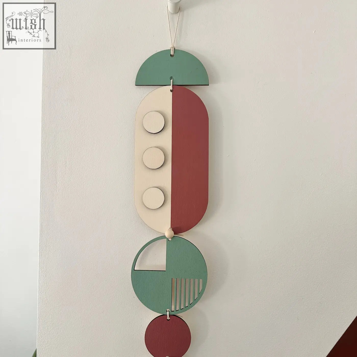 Modern wall art featuring layered wooden geometric shapes in sage green terracotta and cream for minimalist decor