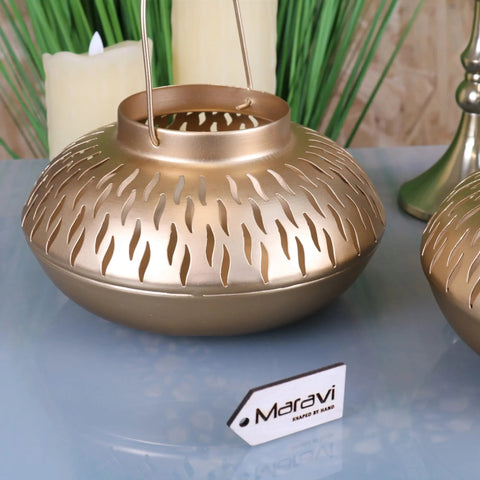 Gold-colored metal mohra gold candle lantern with handcrafted scalloped cutout pattern and hanging wire handle