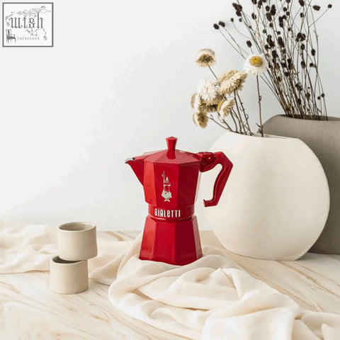 Vibrant red bialetti moka express exclusive with classic geometric design and iconic logo for brewing espresso at home