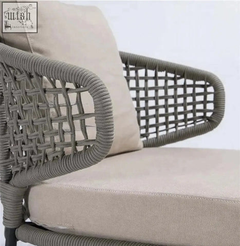 Gray woven wicker mokusei chair with rope backrest and cushioned beige fabric seat for comfy seating