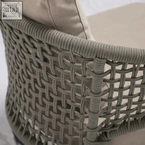Gray woven wicker mokusei chair with rope backrest and beige cushioned seat for comfy seating