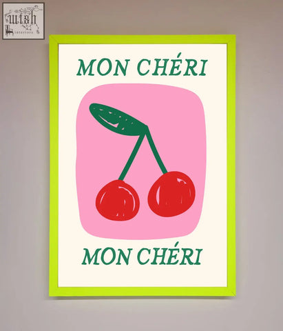A vibrant lime green-framed mon cheri framed poster with red cherries and teal text on a pink background