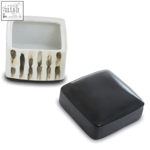 White ceramic mona brushstroke trinket box with black beige feather patterns and a glossy black lid