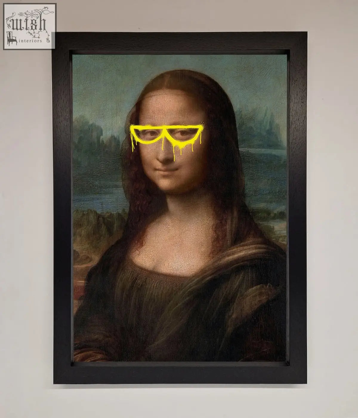 A framed print of the mona lisa wearing bright yellow glasses with dripping paint effects for wall decor