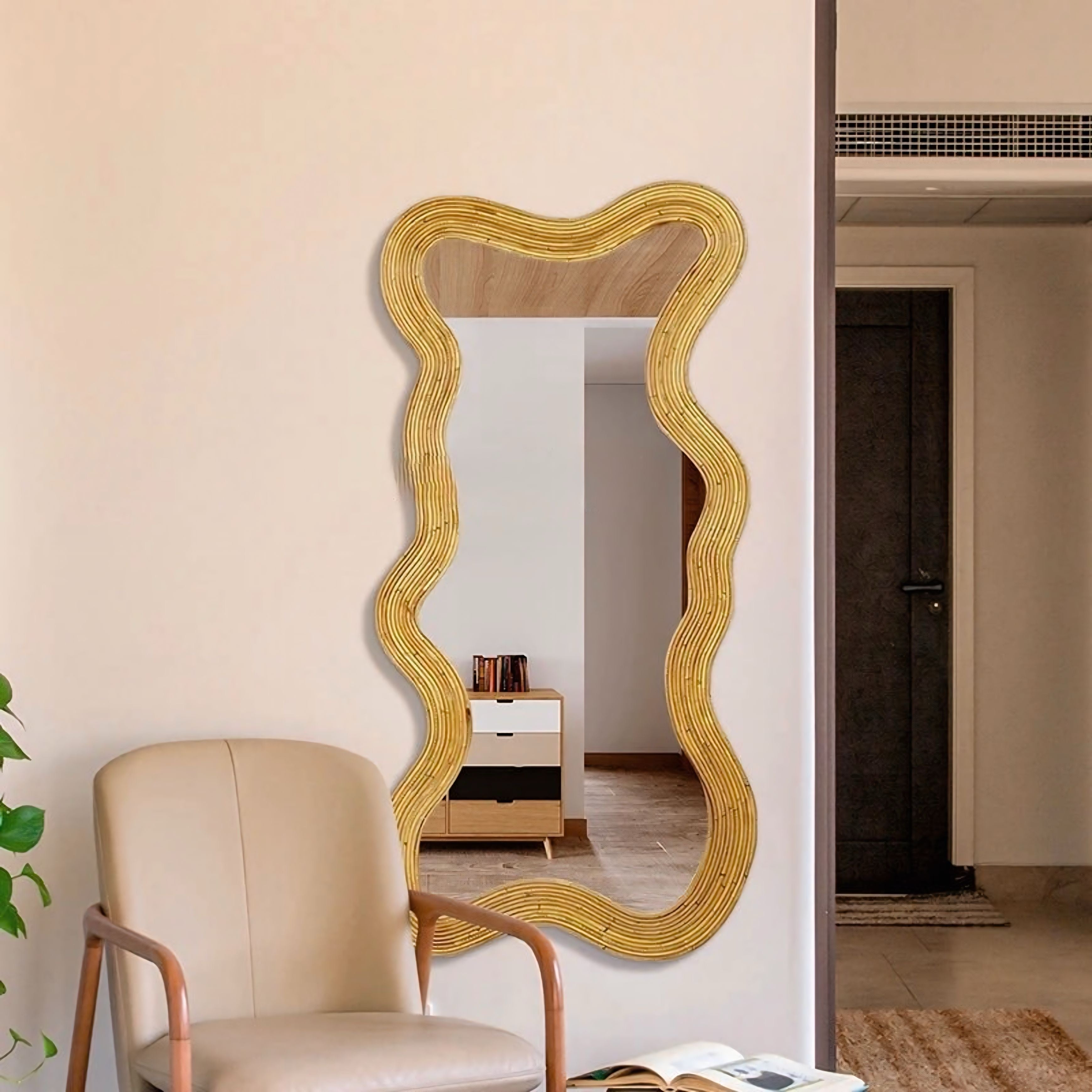 A golden wavy framed moniwa mirror with rattan texture perfect for stylish wall decor