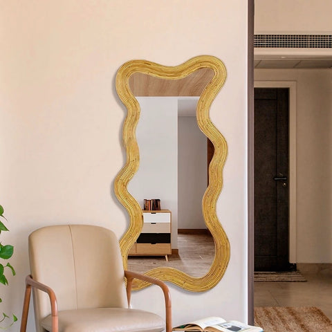A golden wavy framed moniwa mirror with rattan texture perfect for stylish wall decor