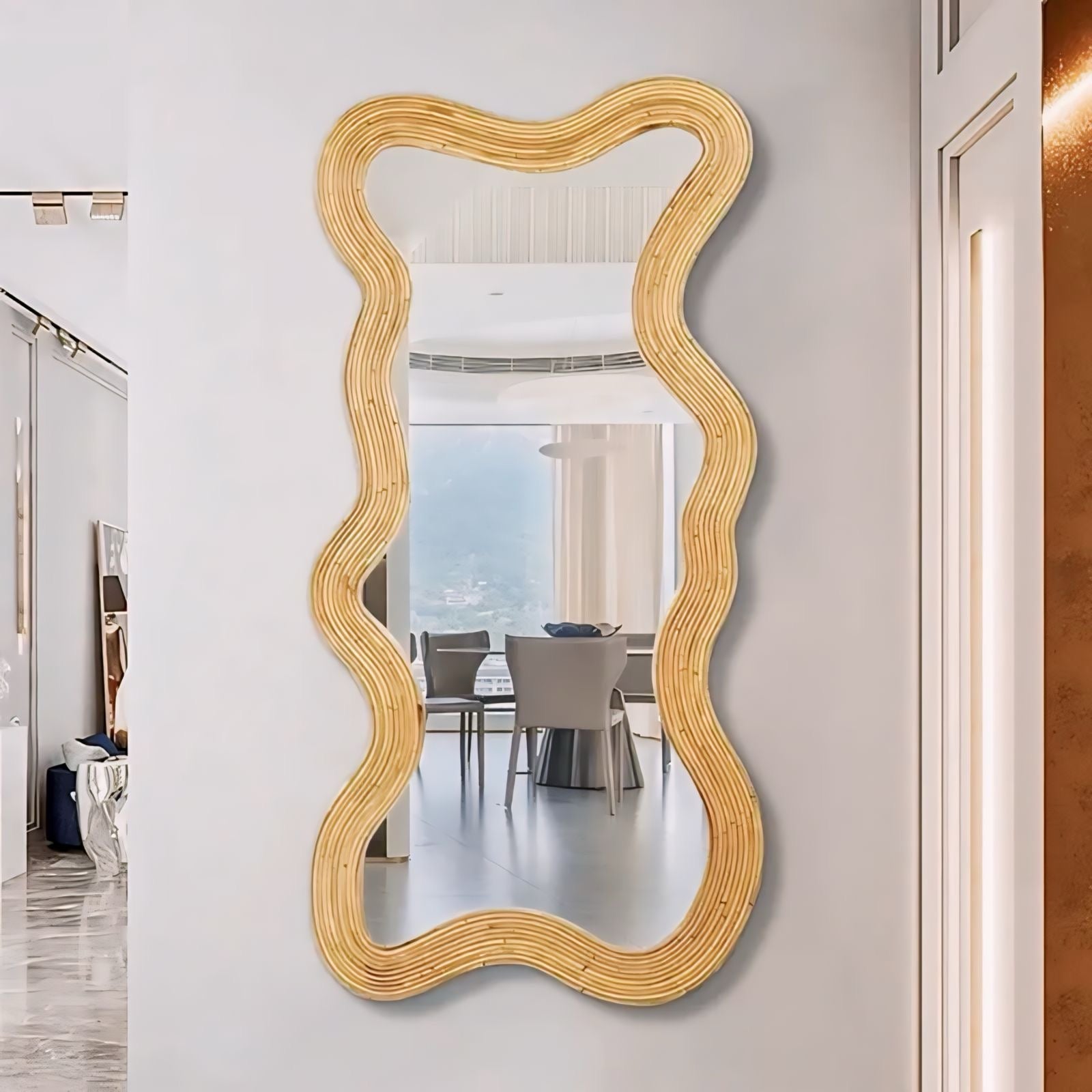 Golden moniwa mirror with wavy rattan-like frame and organic irregular shape for stylish wall decor
