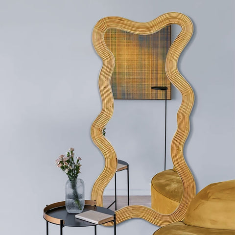Wavy rattan-framed moniwa mirror in golden brown with an organic irregular shape perfect for stylish decor