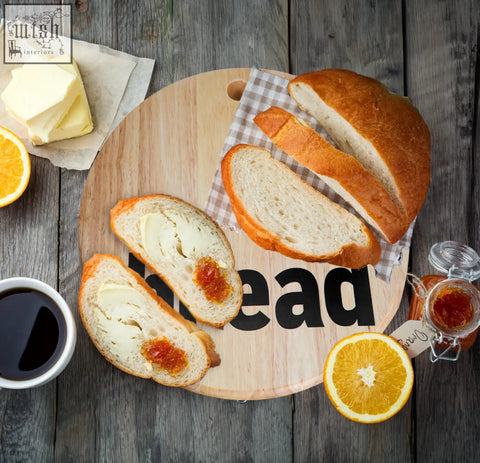 Golden brown sliced mono bread topped with butter and jam on an environmentally friendly rubberwood mono bread board