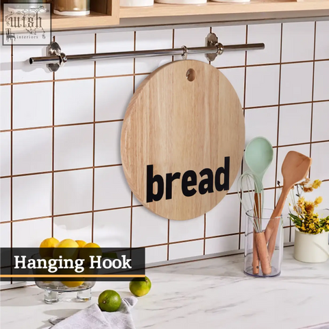 Round wooden mono bread board made from environmentally friendly rubberwood with bread printed in black hanging on metal rod