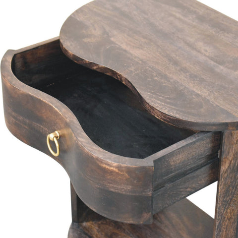 Dark brown wooden monroe bedside table with curved oval top and open drawer featuring gold-toned ring pull