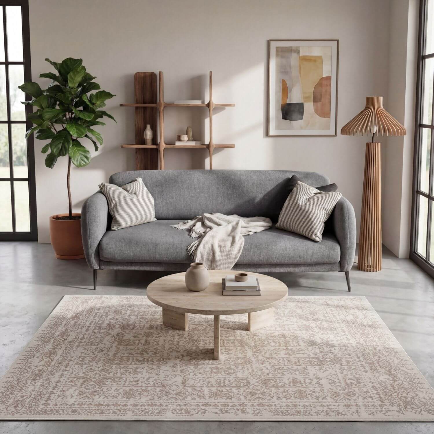 Gray upholstered sofa with striped pillows and textured blanket on a montana cream and beige rug