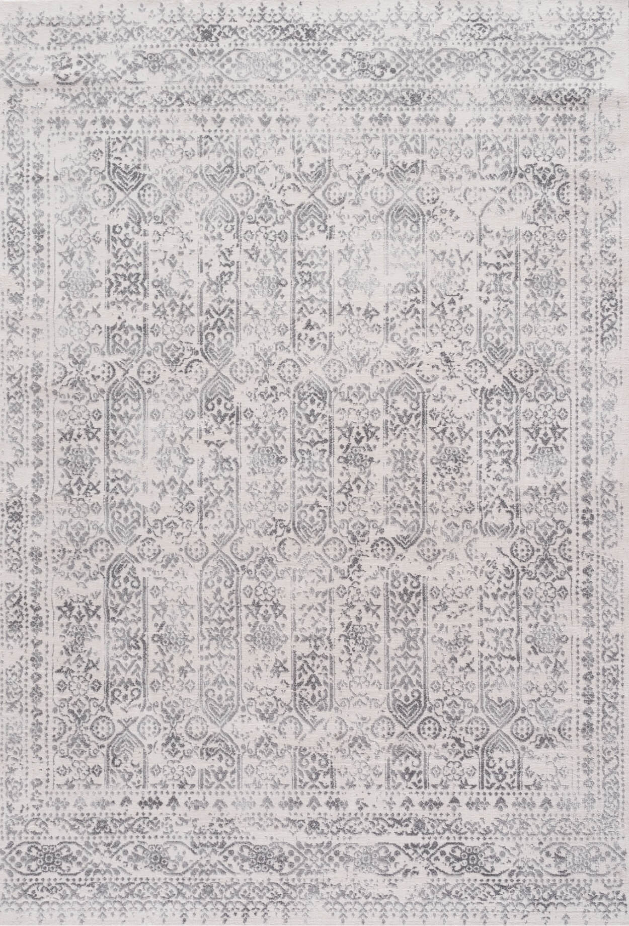 Vintage-style montana cream rug with faded gray and white geometric and floral patterns in vertical columns