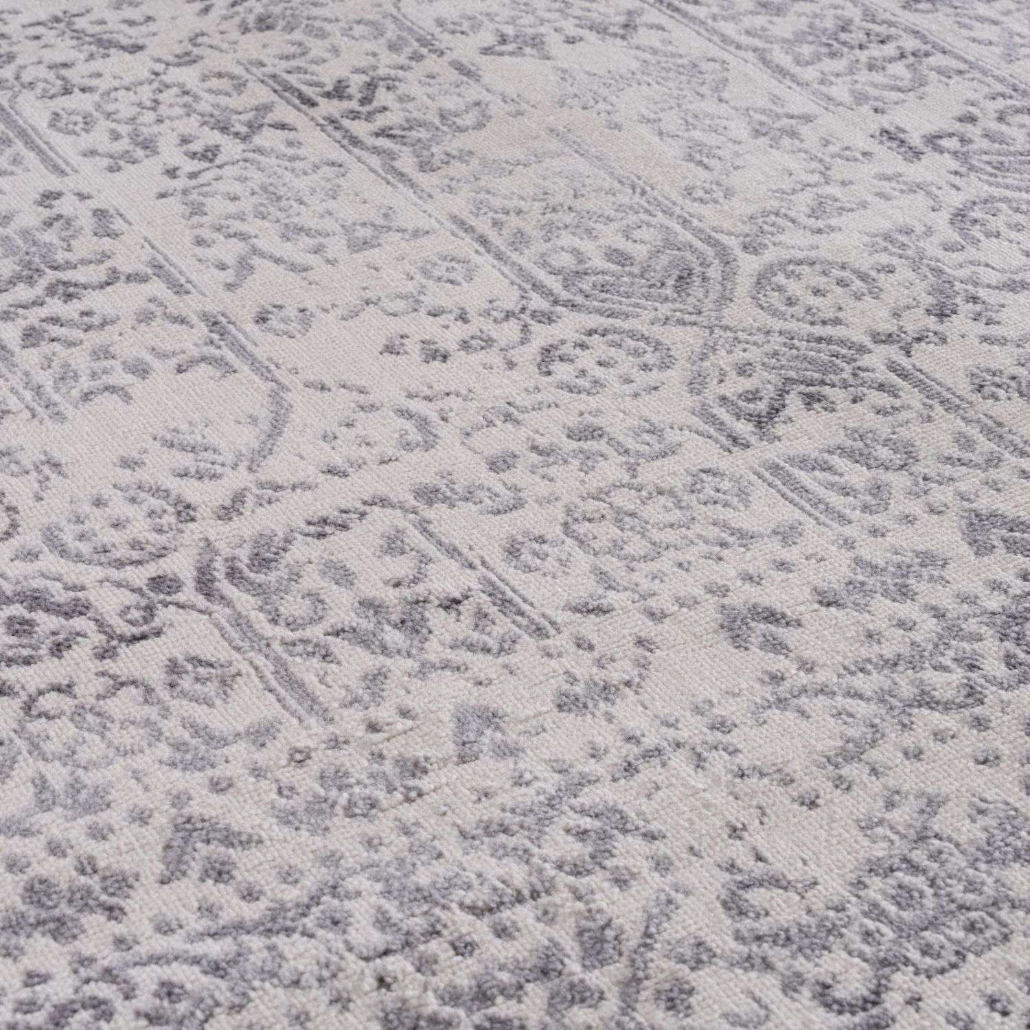 A soft cream rug with a subtle gray vintage floral and geometric pattern from the montana cream collection 3716c