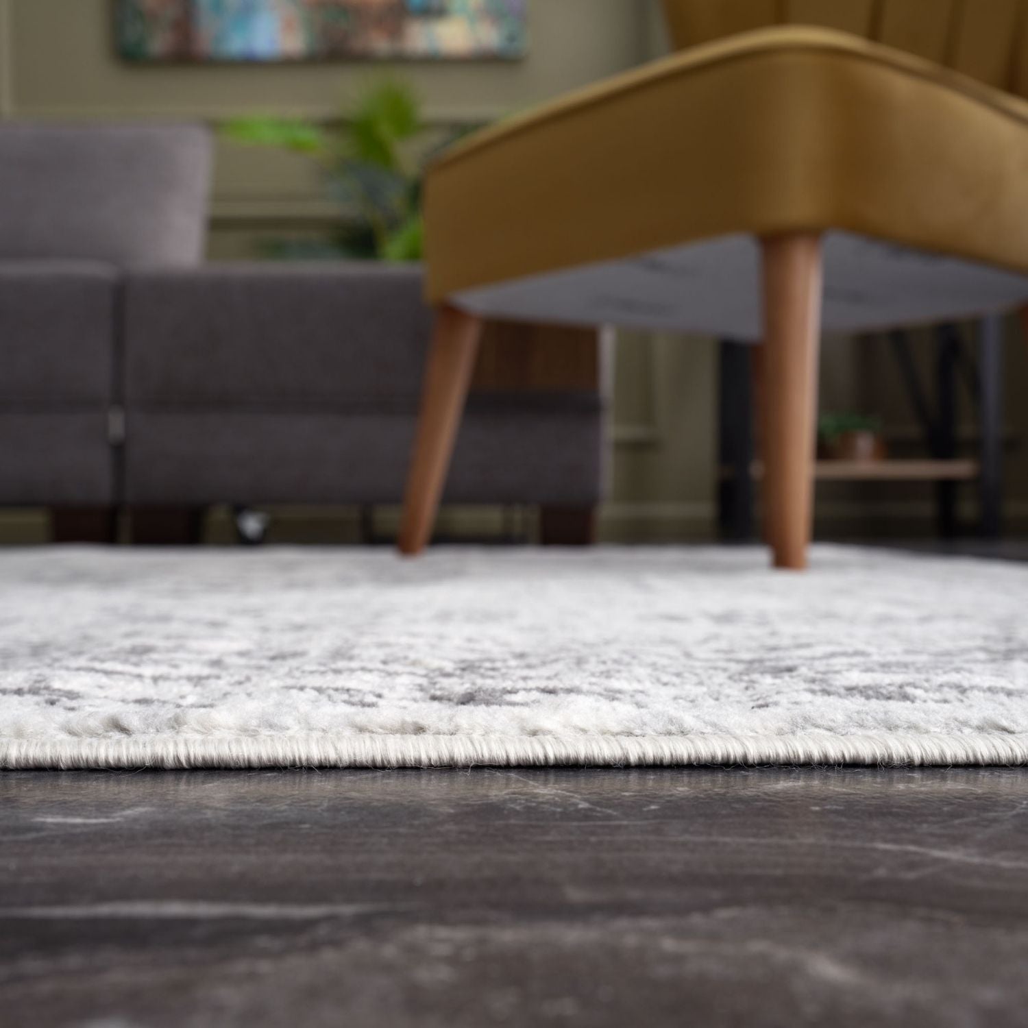 A plush off-white montana vintage grey area rug with subtle gray pattern and fringed edges perfect for cozy spaces