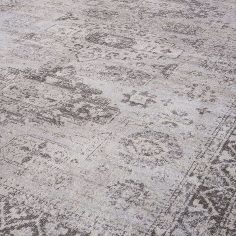 A montana vintage grey rug with a faded distressed pattern in shades of gray and white vintage style area rug