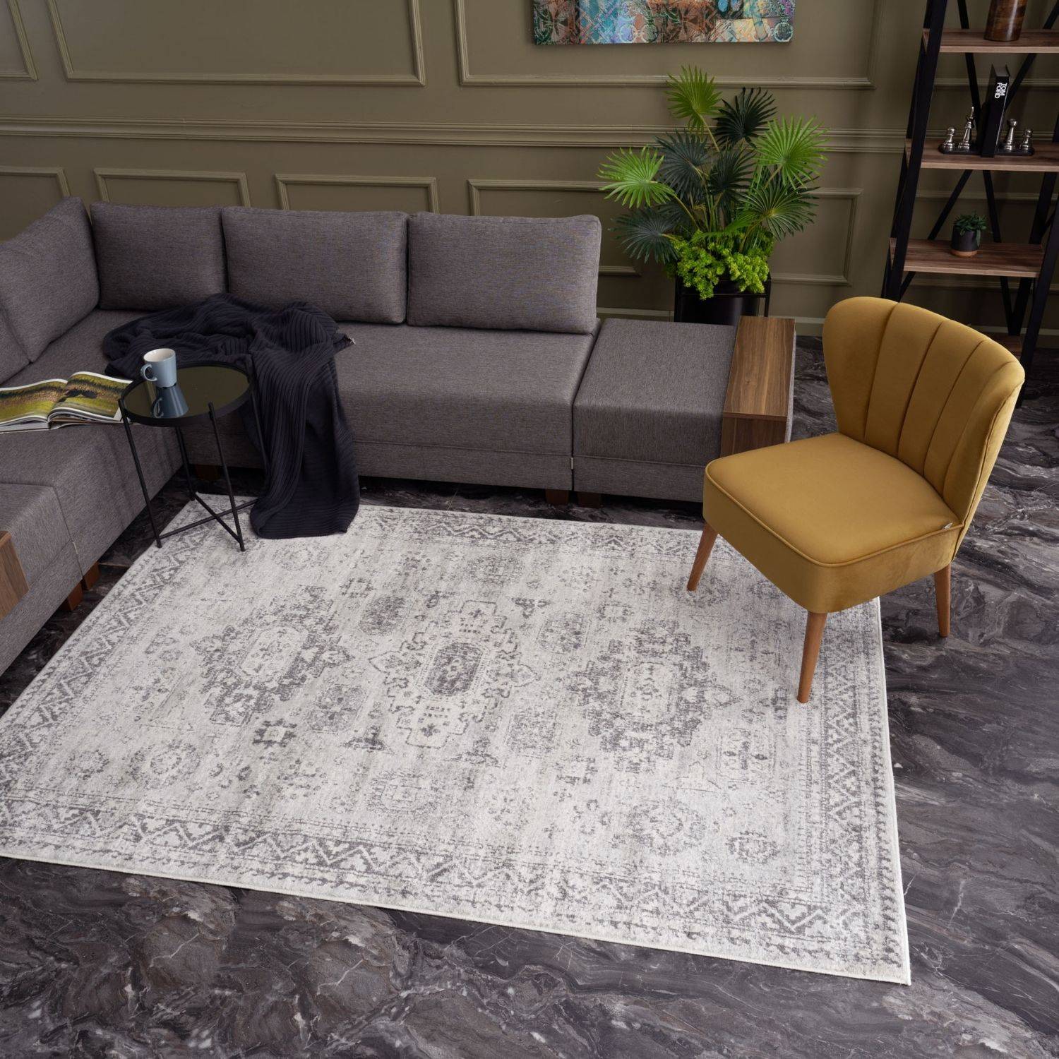 A montana vintage grey area rug with a faded intricate pattern in shades of gray and white perfect for any room