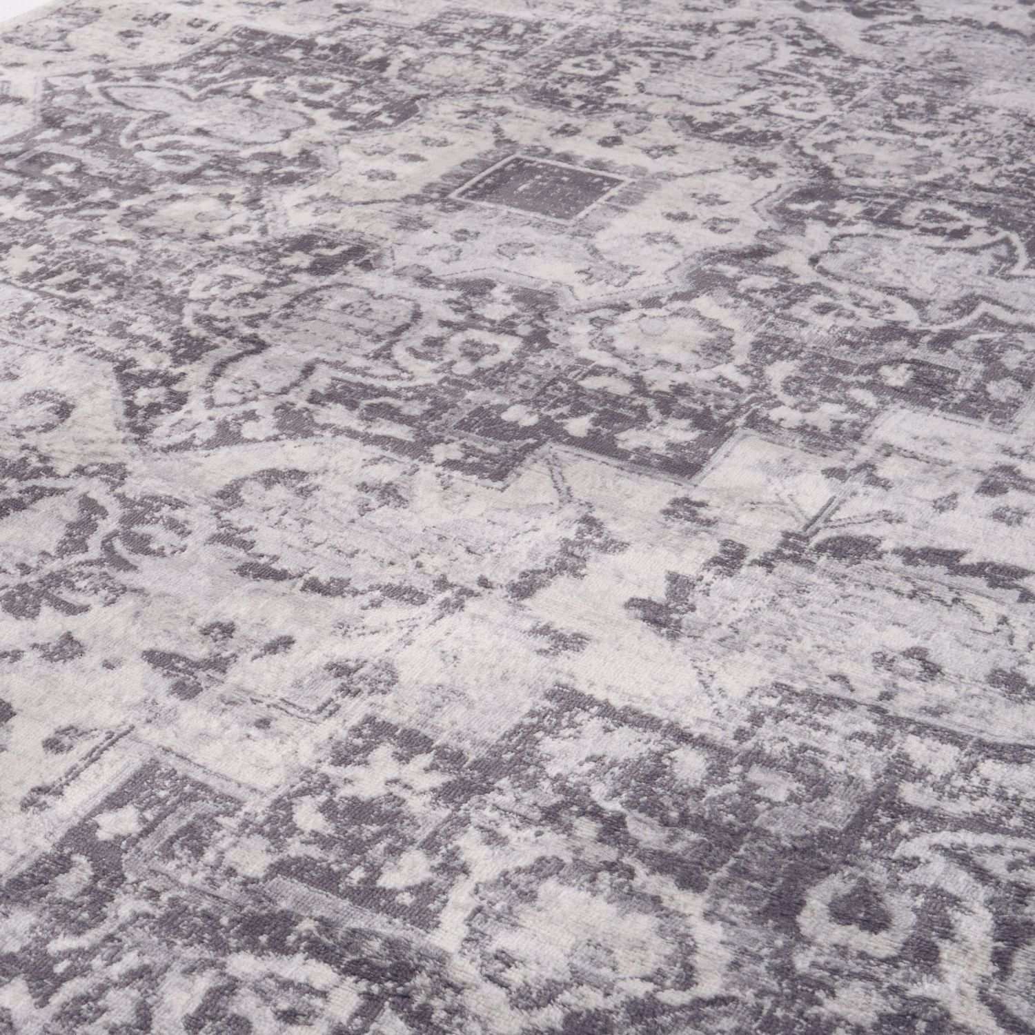 Montana vintage grey area rug with distressed floral and geometric patterns in gray and white tones