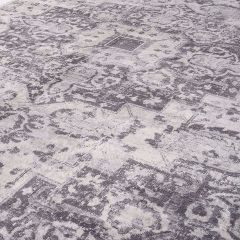 Montana vintage grey area rug with distressed floral and geometric patterns in gray and white tones