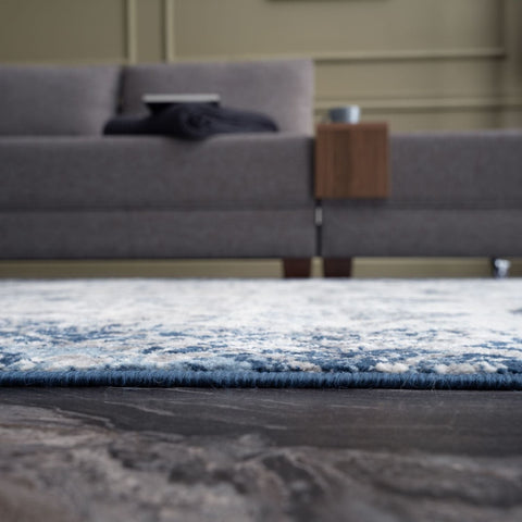 Blue and white patterned montana vintage navy area rug with textured fringed edge for cozy living spaces