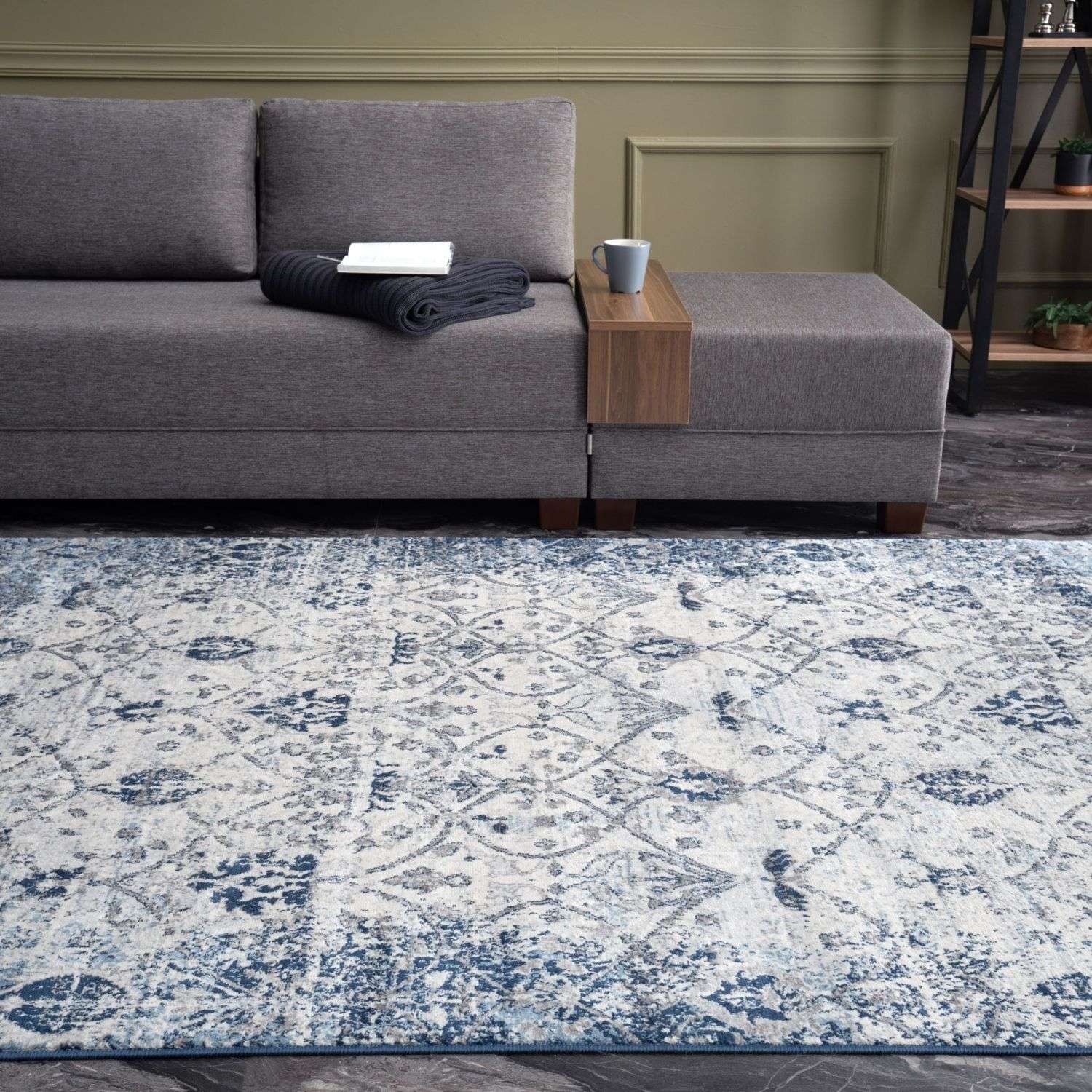 A montana vintage navy area rug with distressed blue and cream floral pattern and intricate geometric design