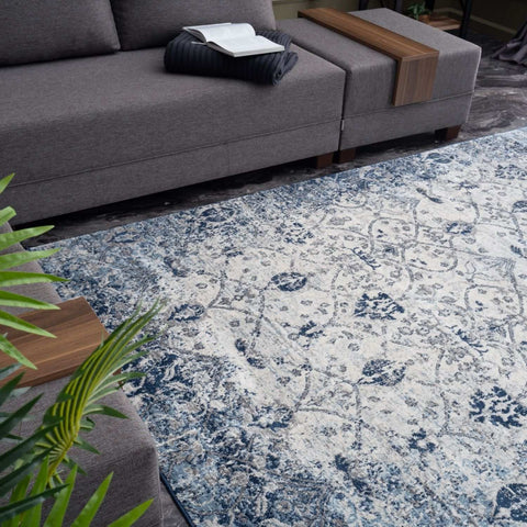A montana vintage navy rug featuring a distressed blue and cream floral pattern with plush pile material