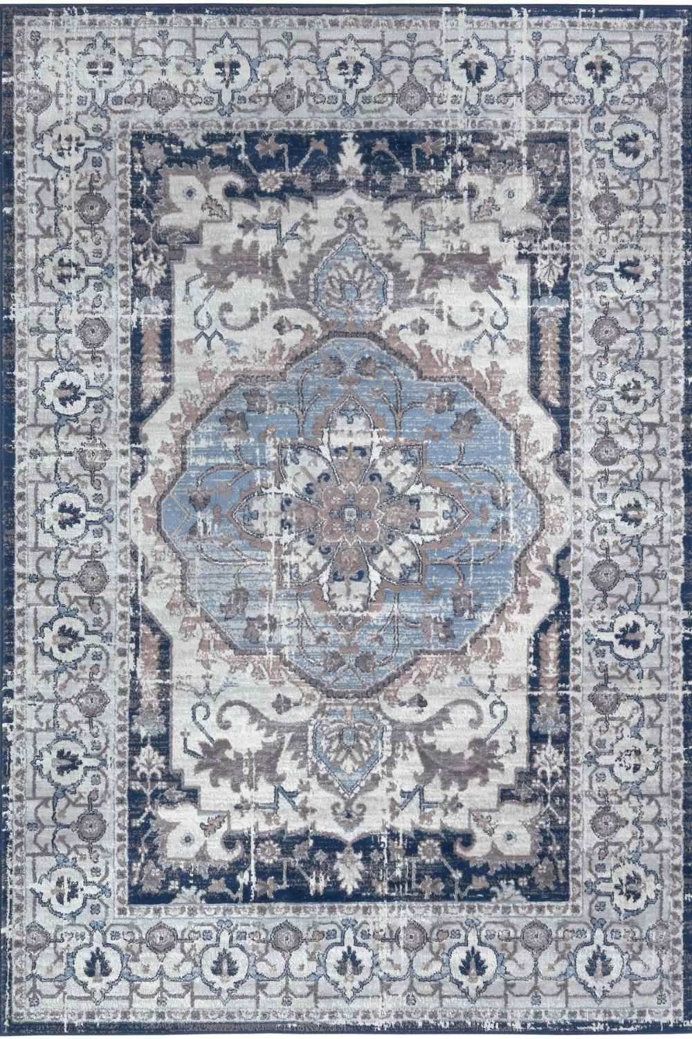 Vintage navy area rug with faded blue cream medallion and intricate navy gray beige borders in montana vintage style