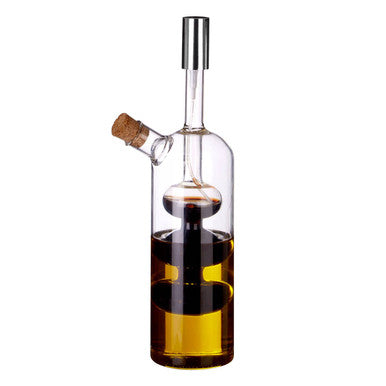 Clear glass montela oil and vinegar pourer with silver spout and cork stopper showing dark and amber layers