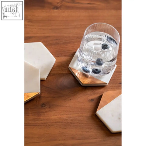 Monzaro set of 4 white marble coasters with hexagonal shape and copper inlay gold-edged accents
