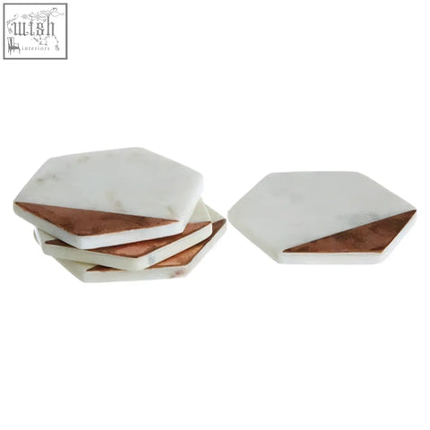 Set of four white marble coasters with copper inlay hexagonal design perfect for stylish drink protection