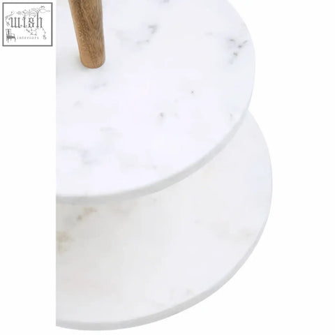 White marble two tier cake stand with wooden central support featuring acacia wood cake stand design