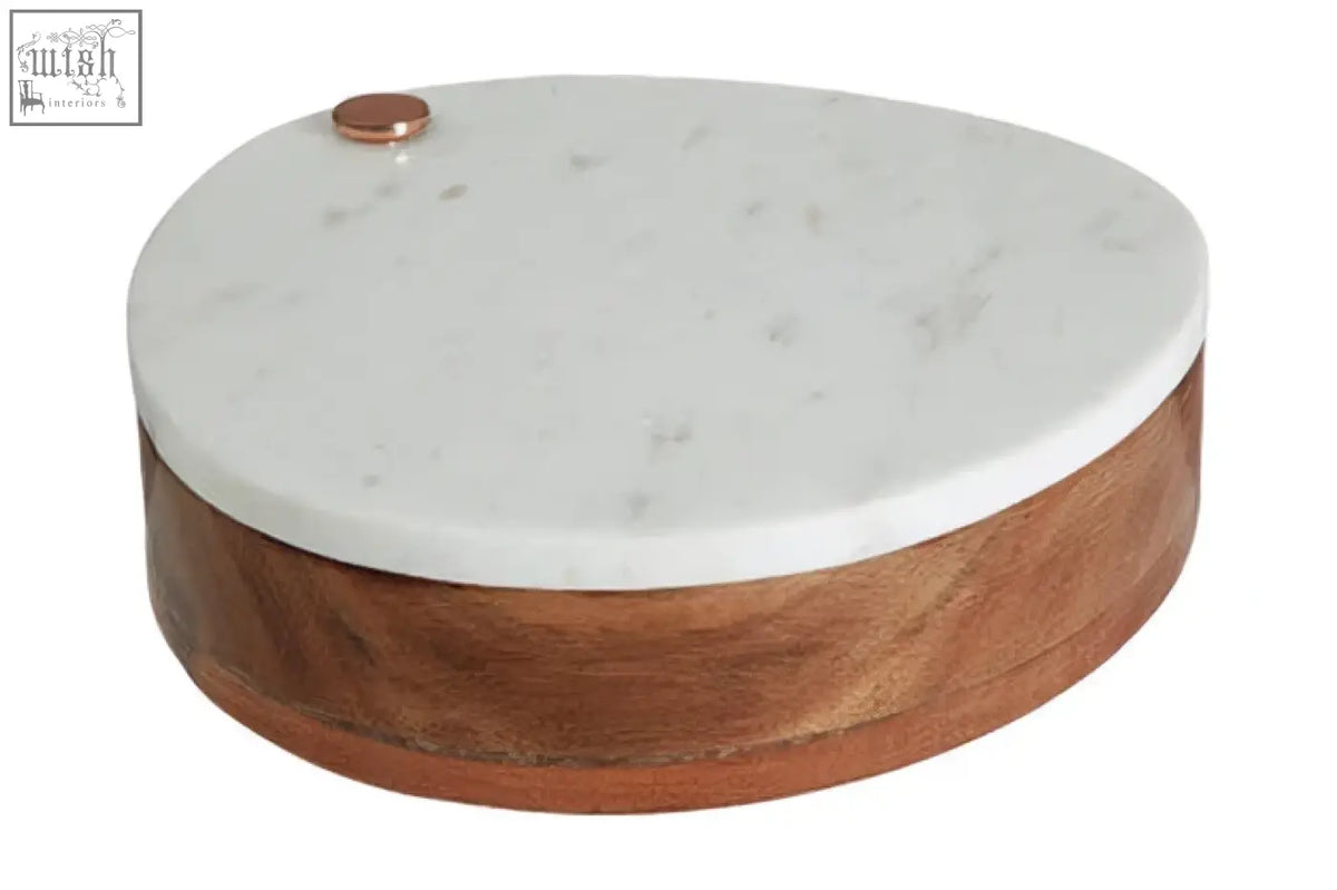 A sleek oval wood cheese knife box with white marble top and copper knob from monzaro cheese board set